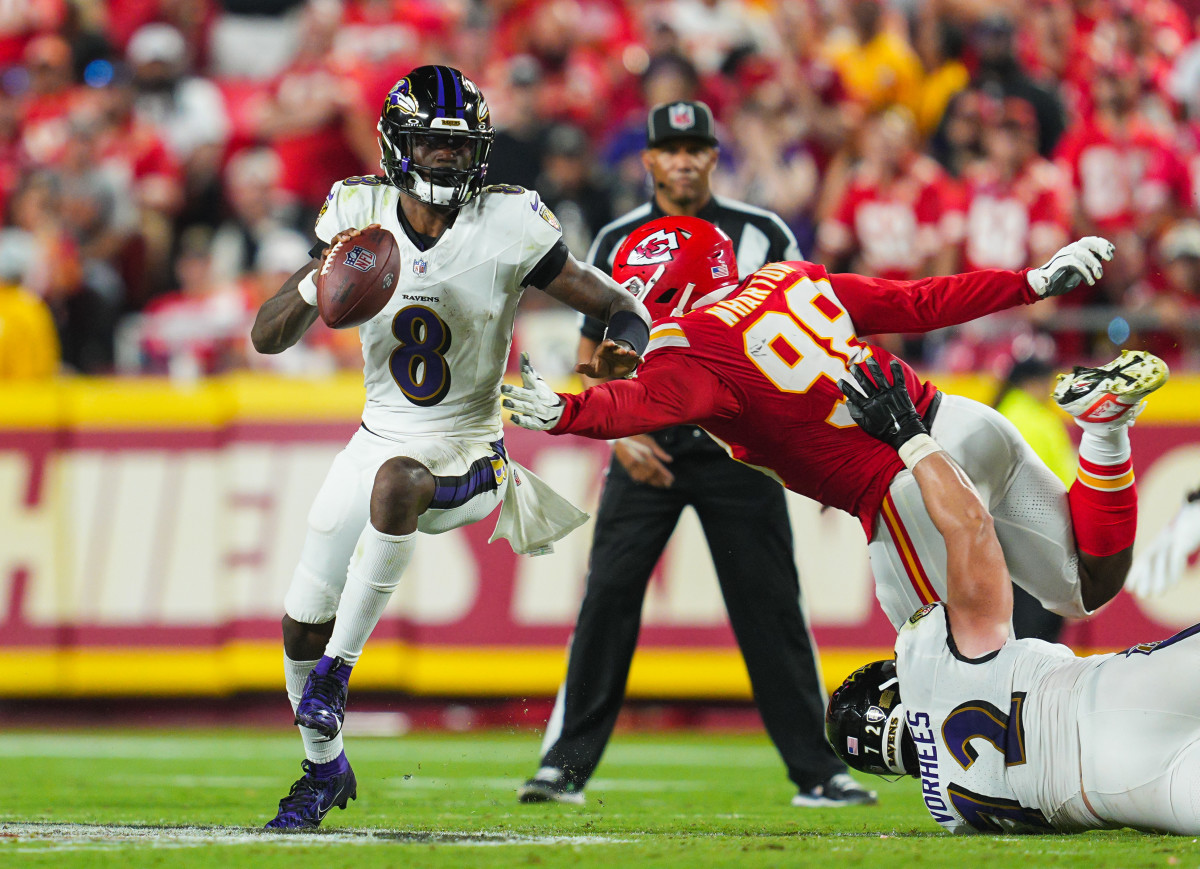 Baltimore Ravens quarterback Lamar Jackson (8) scrambles against Kansas City Chiefs defensive tackle Tershawn Wharton (98) during the first half.