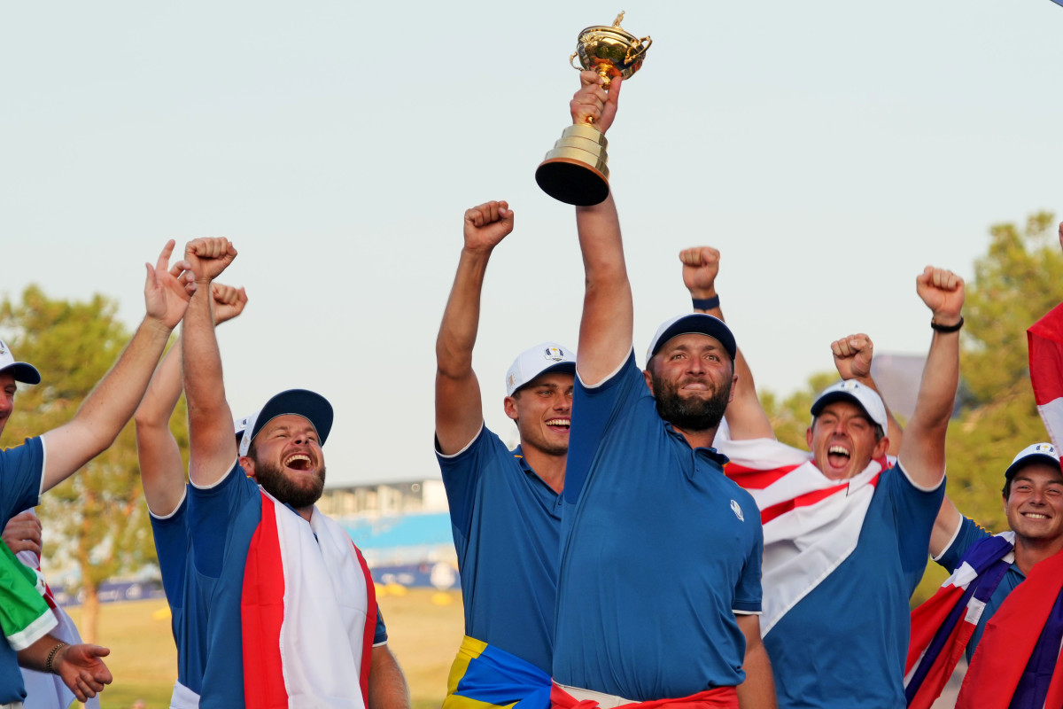 Team Europe golfer Jon Rahm and Team Europe celebrate with the Ryder Cup after beating Team USA during the final day of the 44th Ryder Cup golf competition at Marco Simone Golf and Country Club.