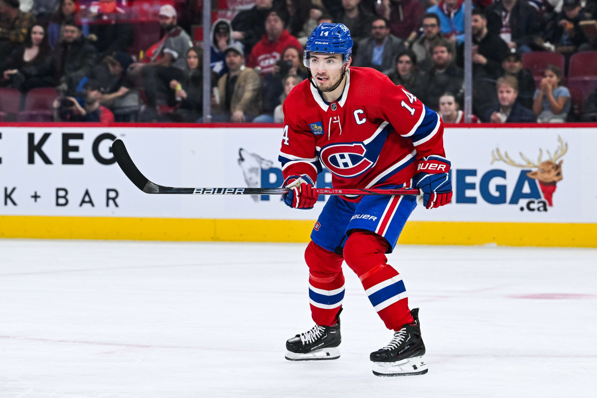 Montreal Canadiens center Nick Suzuki (14) tracks the play.
