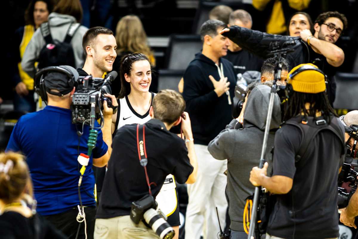 Caitlin Clark poses with Connor McCaffery at Carver-Hawkeye Arena in Iowa.