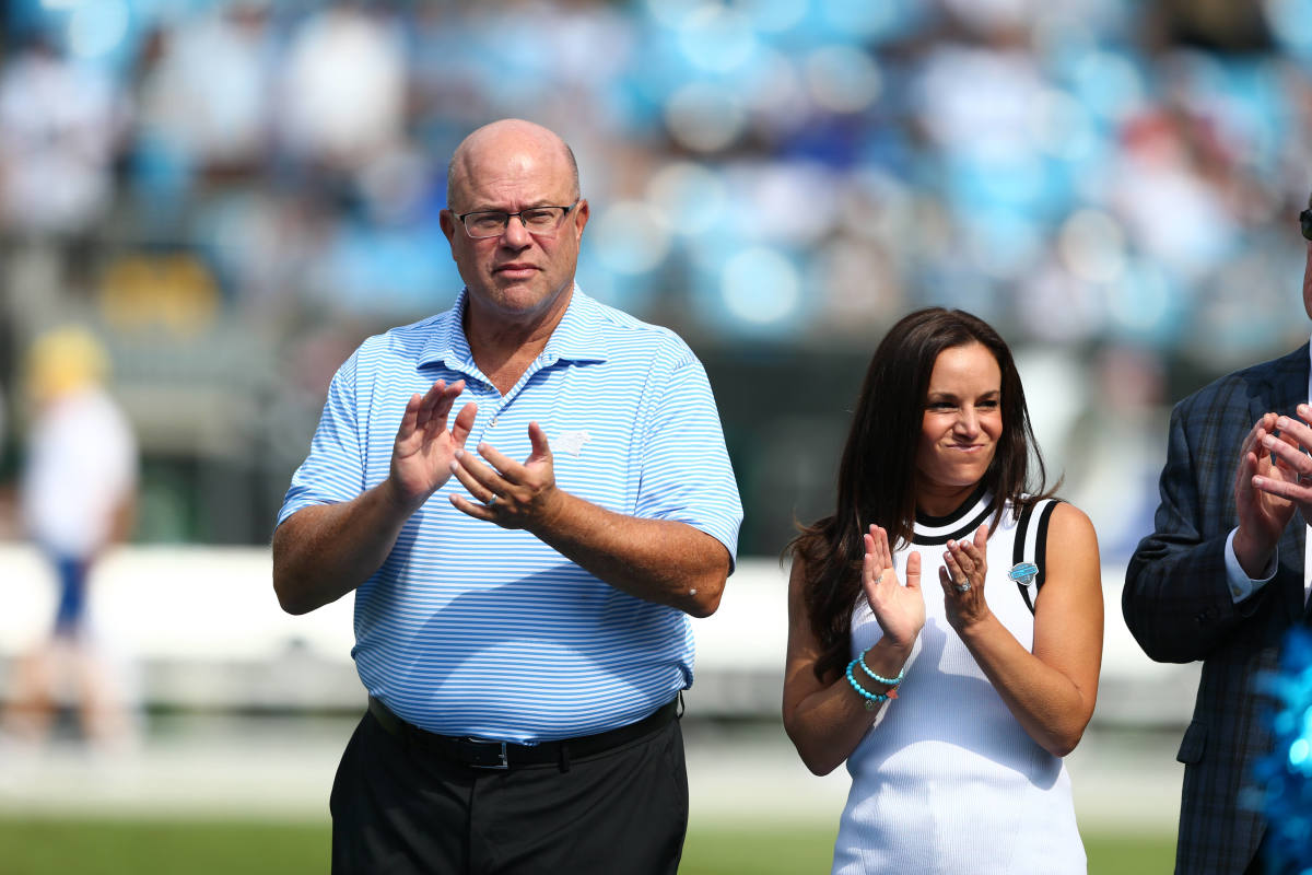 Carolina Panthers owner David Tepper stands on the field.