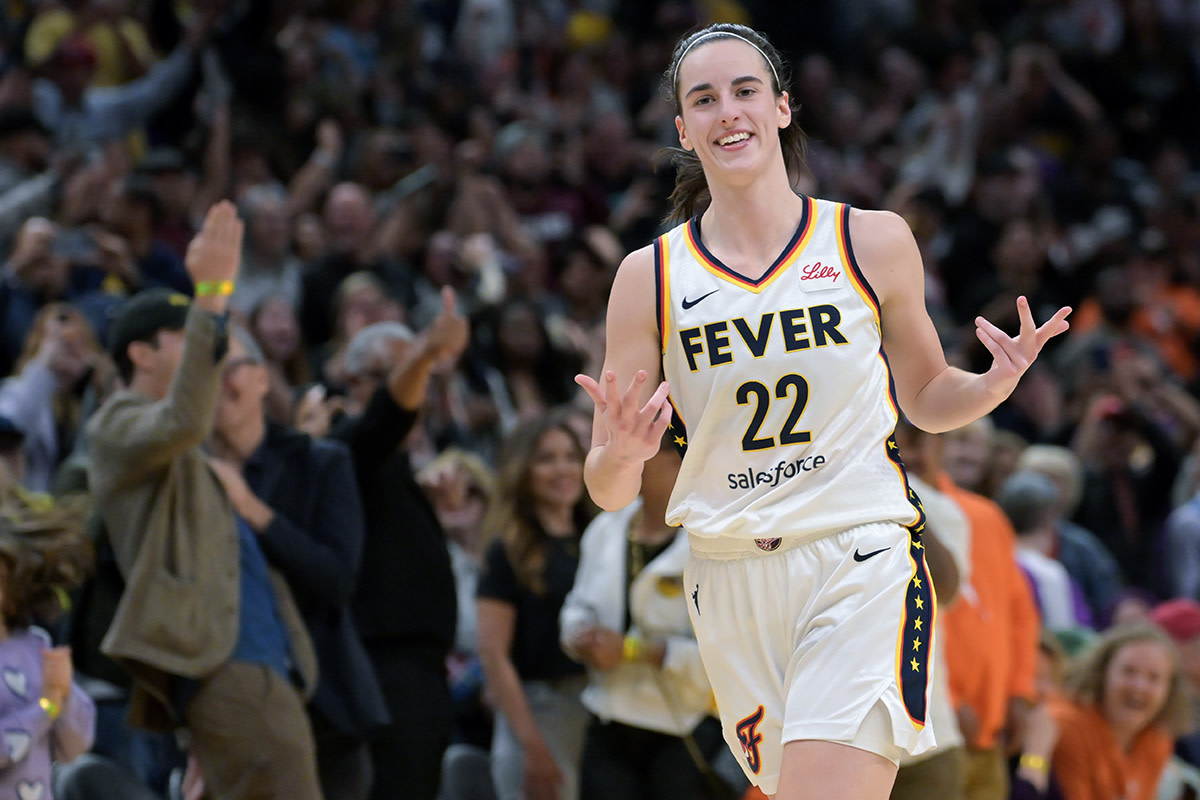 May 24, 2024; Los Angeles, California, USA; Indiana Fever guard Caitlin Clark (22) smiles as she heads down court after a 3-point basket in the final seconds of the game against the Los Angeles Sparks at Crypto.com Arena.