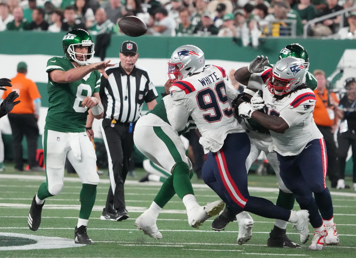 Sep 19, 2024; East Rutherford, New Jersey, USA; New York Jets quarterback Aaron Rodgers (8) tosses a pass against the New England Patriots in the 2nd half at MetLife Stadium.