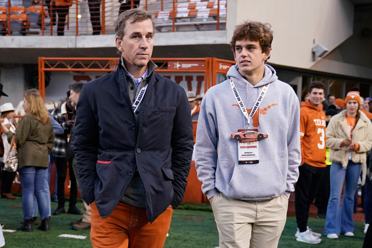 Texas Longhorns quarterback recruit Arch Manning along with his father Cooper Manning.