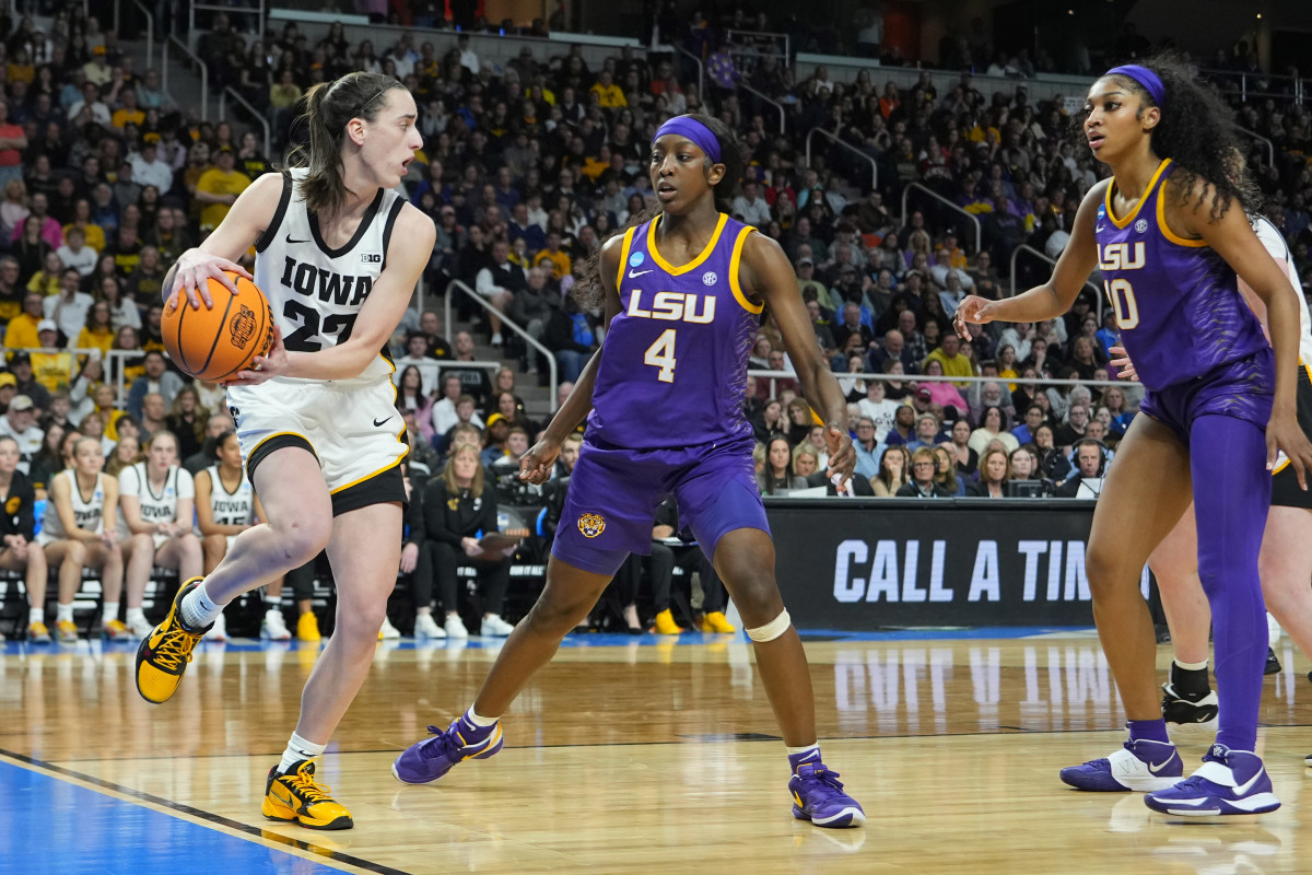 Iowa Hawkeyes guard Caitlin Clark (22), LSU Tigers guard Flau'jae Johnson (4) and LSU Tigers forward Angel Reese (10).