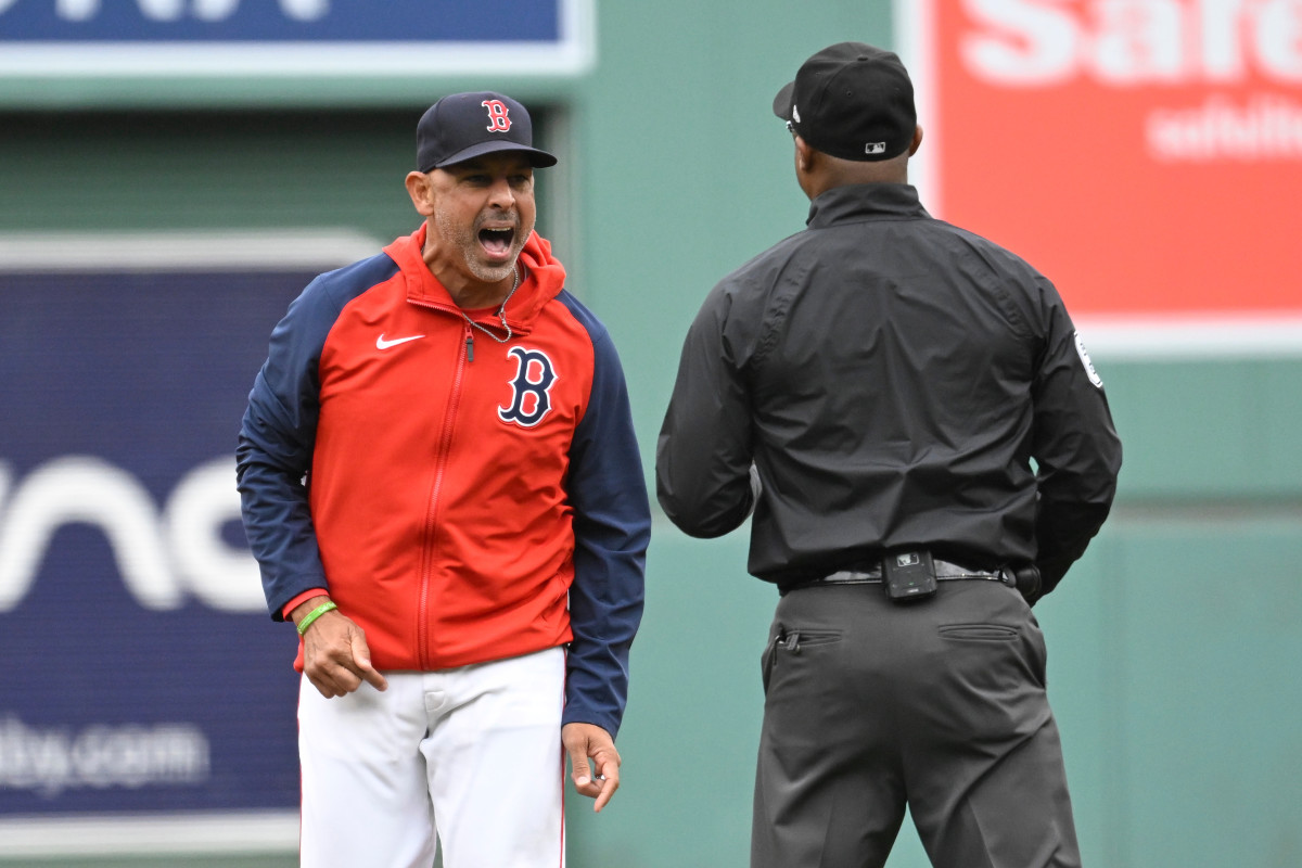 Sep 22, 2024; Boston, Massachusetts, USA; Boston Red Sox manager Alex Cora (13) argues his case to umpire Alan Porter (64) during the first inning against the Minnesota Twins at Fenway Park.