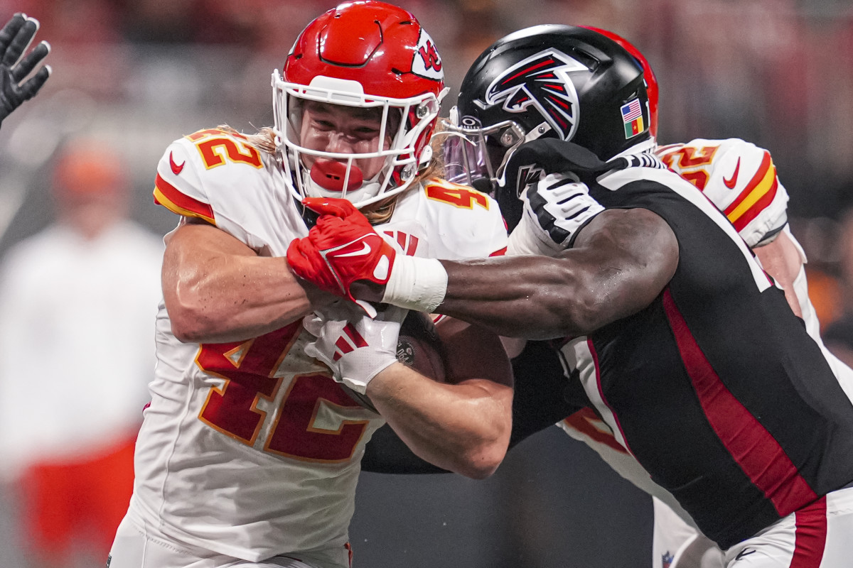 Kansas City Chiefs running back Carson Steele (42) is tackled by Atlanta Falcons linebacker Arnold Ebiketie (17) during the second half at Mercedes-Benz Stadium.