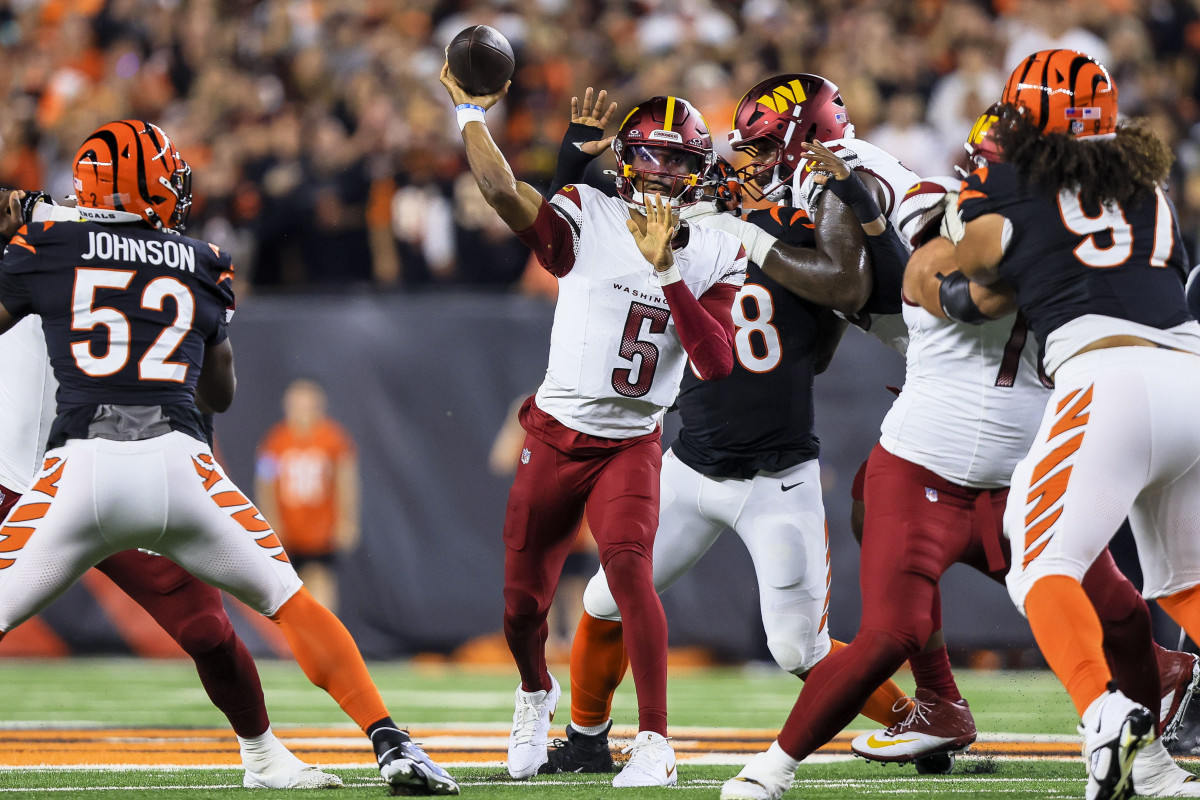 Sep 23, 2024; Cincinnati, Ohio, USA; Washington Commanders quarterback Jayden Daniels (5) throws a pass against the Cincinnati Bengals in the first half at Paycor Stadium