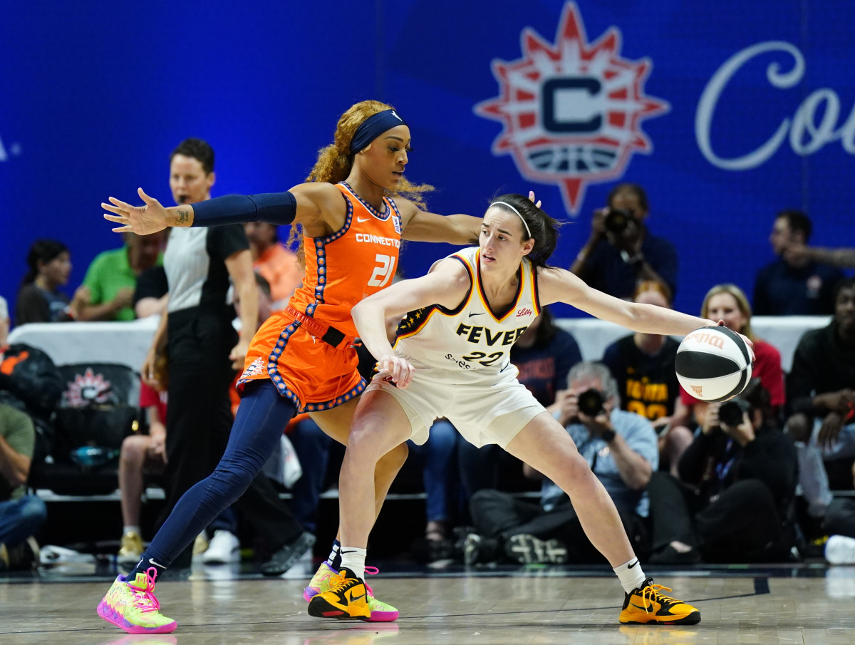 Indiana Fever guard Caitlin Clark (22) moves the ball against Connecticut Sun guard DiJonai Carrington (21) in the first quarter at Mohegan Sun Arena.