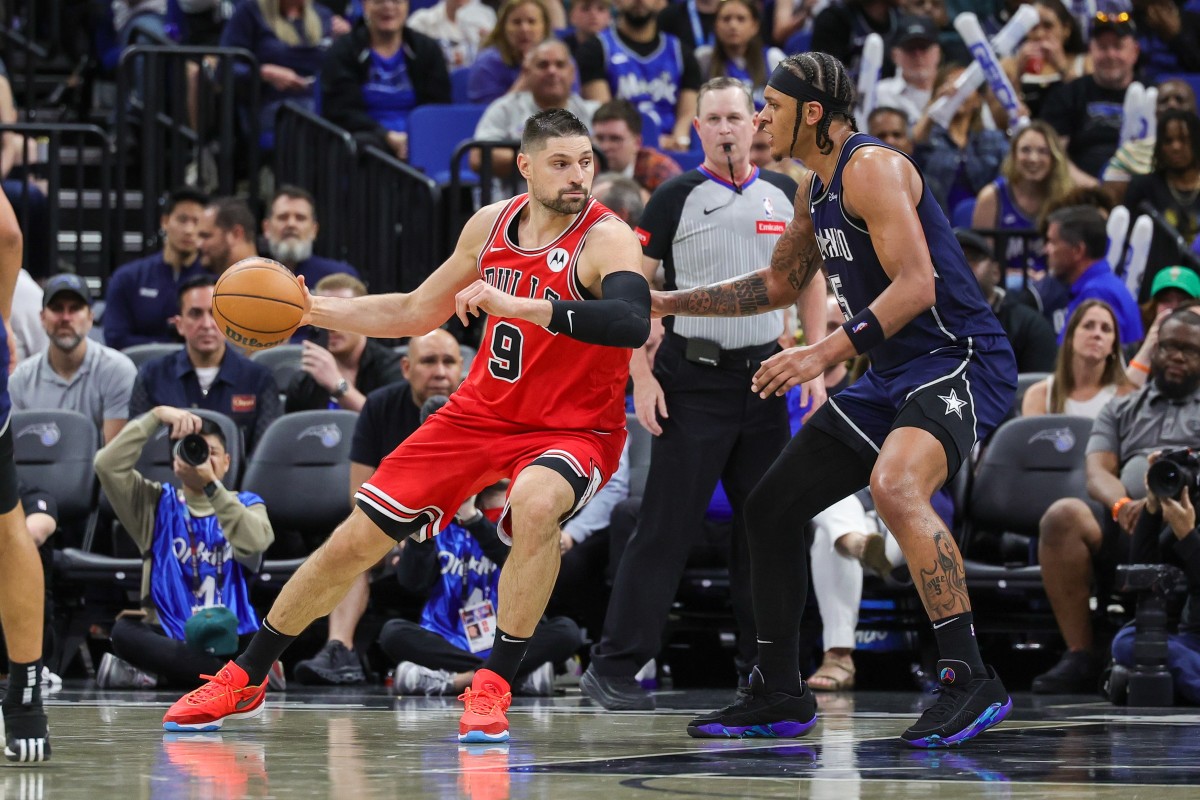 Chicago Bulls center Nikola Vucevic drives into the post as Orlando Magic forward Paolo Banchero defends at KIA Center on April 7, 2024.