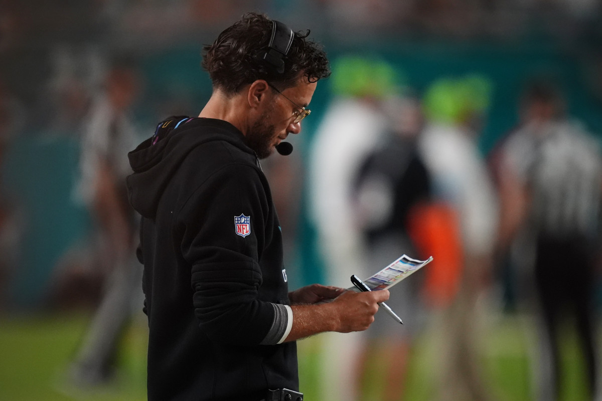 Miami Dolphins head coach Mike McDaniel looks over his play card.