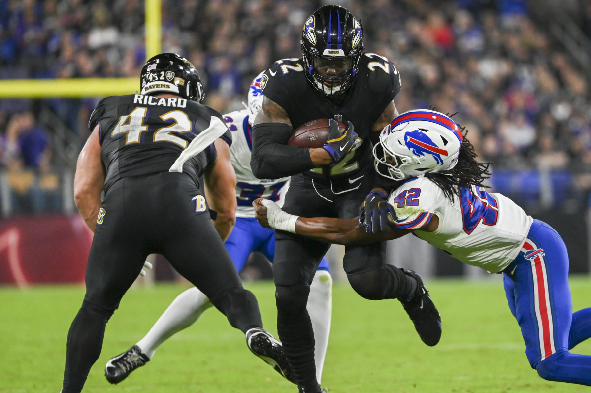 Sep 29, 2024; Baltimore, Maryland, USA; Baltimore Ravens running back Derrick Henry (22) runs through Buffalo Bills linebacker Dorian Williams (42) tackle attempt during the first half at M&T Bank Stadium. Mandatory Credit: Tommy Gilligan-Imagn Images