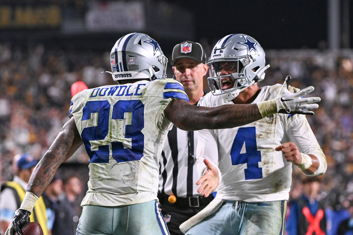 Dallas Cowboys QB Dak Prescott celebrates a touchdown with Rico Dowdle against the Pittsburgh Steelers.