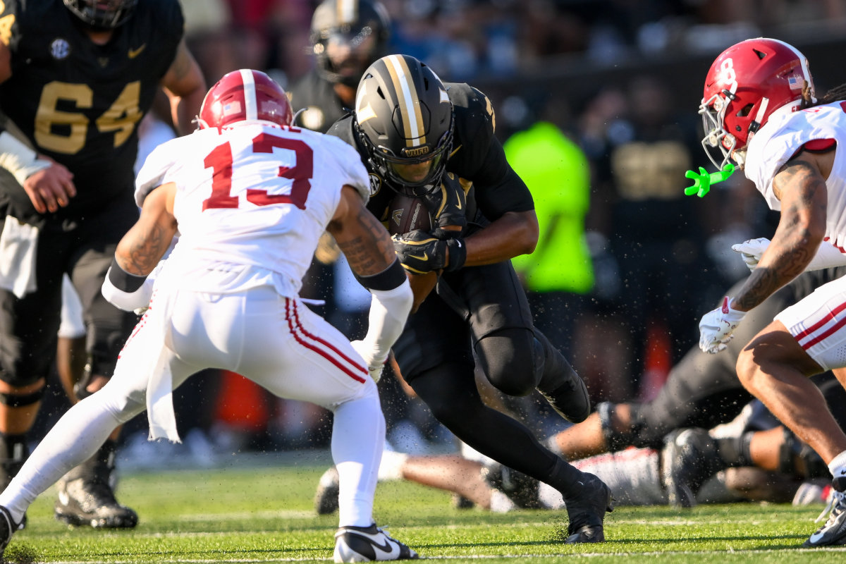 Malachi Moore of the Alabama Crimson Tide and AJ Newberry of the Vanderbilt Commodores