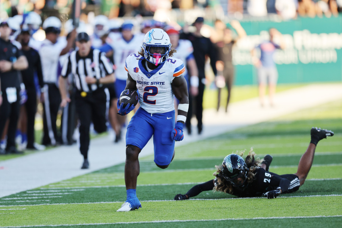 Oct 12, 2024; Honolulu, Hawaii, USA; Boise State Broncos running back Ashton Jeanty (2) gets past Hawaii Rainbow Warriors defensive back Kilinahe Mendiola-Jensen (29) for a touchdown during the first quarter at Clarence T.C. Ching Athletics Complex. Mandatory Credit: Marco Garcia-Imagn Images  