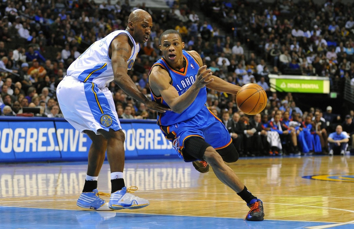  Oklahoma City Thunder guard Russell Westbrook (0) drives around the defense of Denver Nuggets guard Chauncey Billups (1) in the second half at the Pepsi Center.