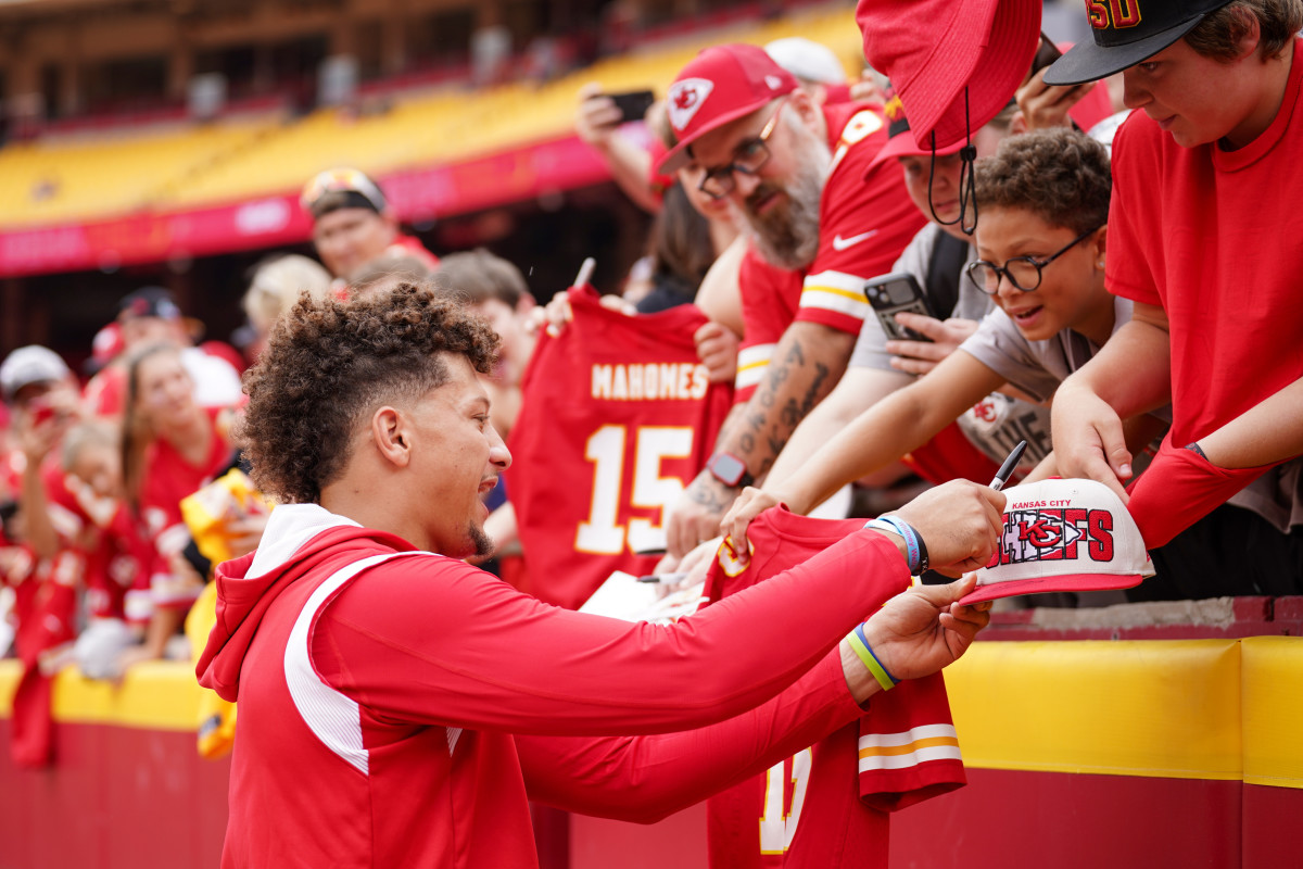 Aug 26, 2023; Kansas City, Missouri, USA; Kansas City Chiefs quarterback Patrick Mahomes (15) signs autographs for fans prior to a game against the Cleveland Browns at GEHA Field at Arrowhead Stadium. Mandatory Credit: Denny Medley-USA TODAY Sports  