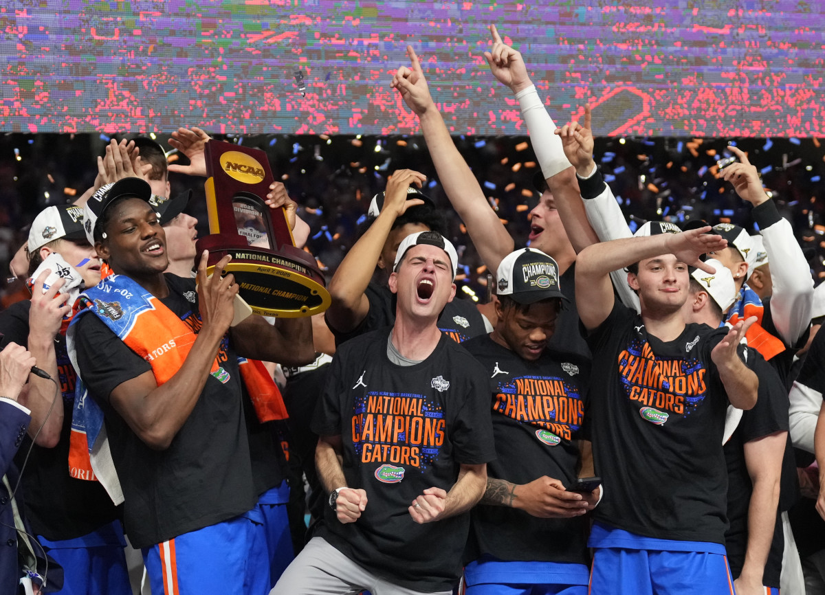 Florida Gators players hoist the trophy.