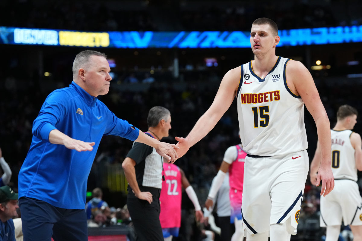 Denver Nuggets head coach Michael Malone congratulates center Nikola Jokic (15) in the fourth quarter against the Washington Wizards at Ball Arena.