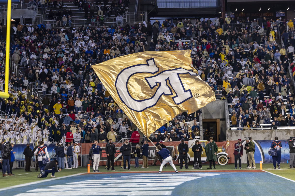  A Georgia Tech Yellow Jackets cheerleader waves the team flag during the second half of the 2024 Birmingham Bowl at Protective Stadium.