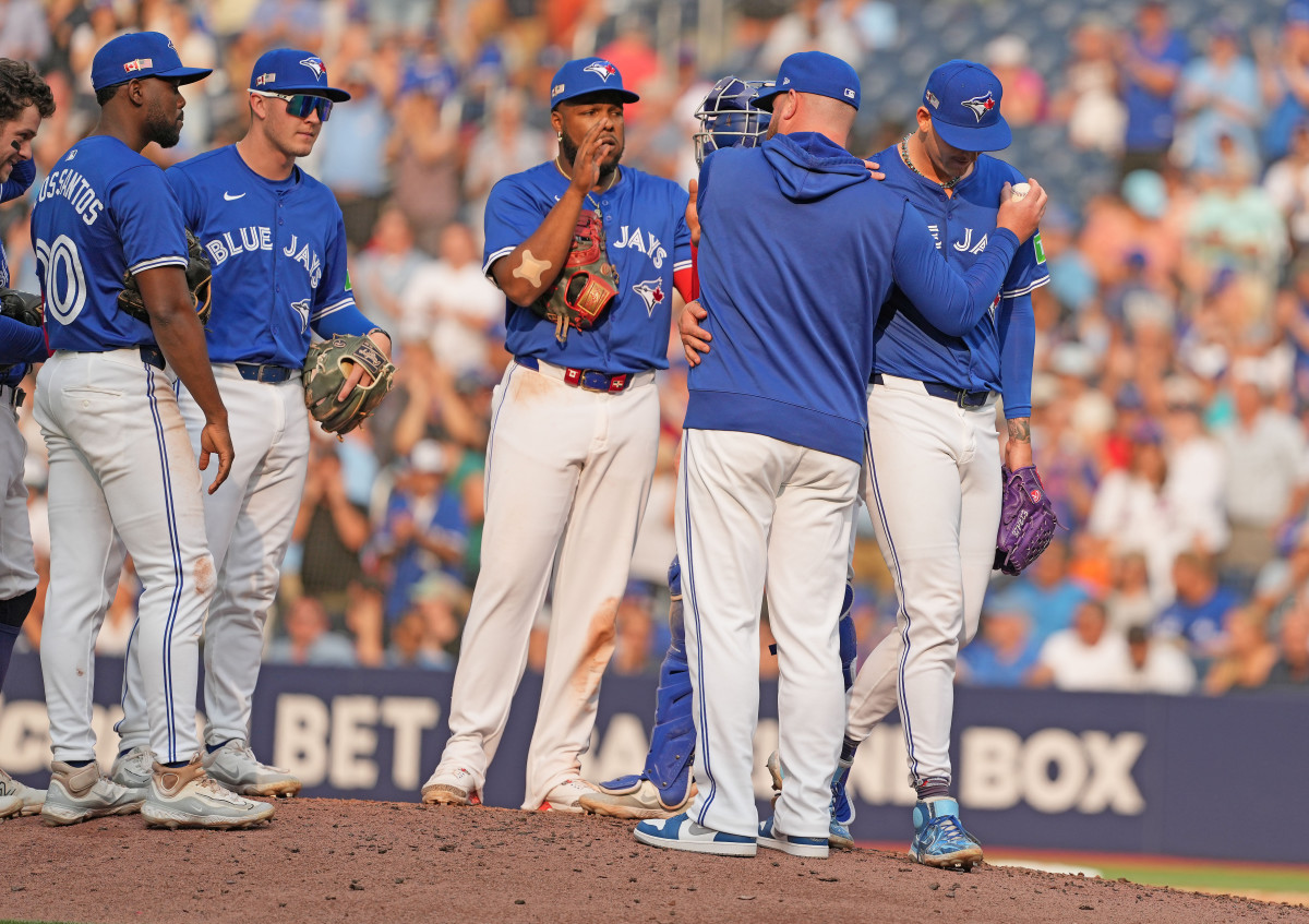 Toronto Blue Jays pitcher Bowden Francis (44) and manager John Schneider (14)