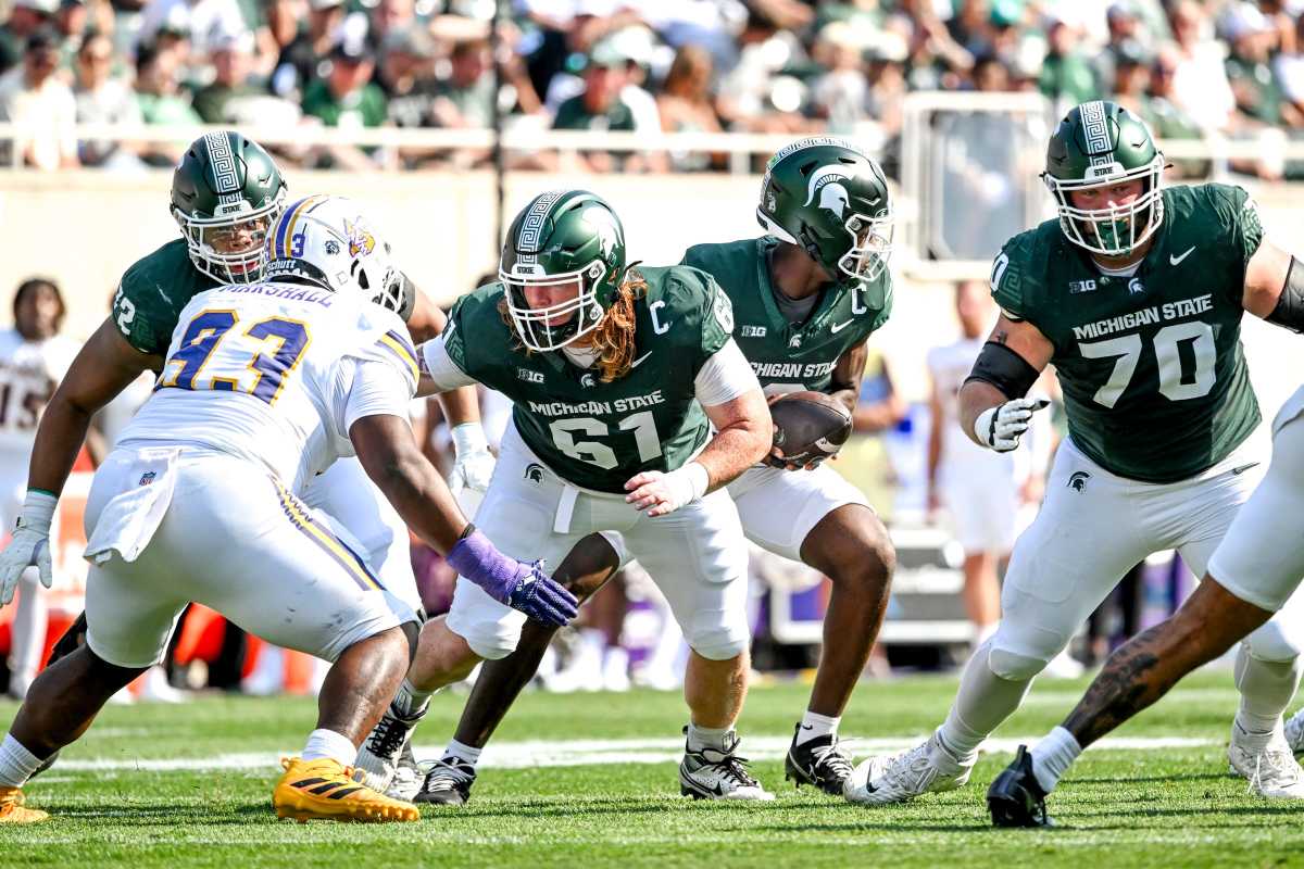 Tanner Miller (No. 61) and Luke Newman (No. 70) block for Michigan State during a game against Prairie View A&M