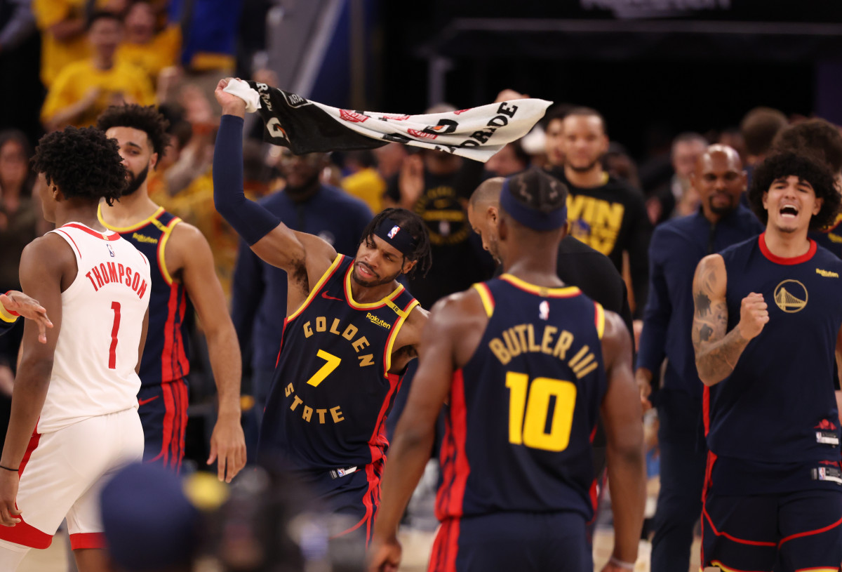 Warriors guard Buddy Hield (7) waves a towel after a win against the Rockets.