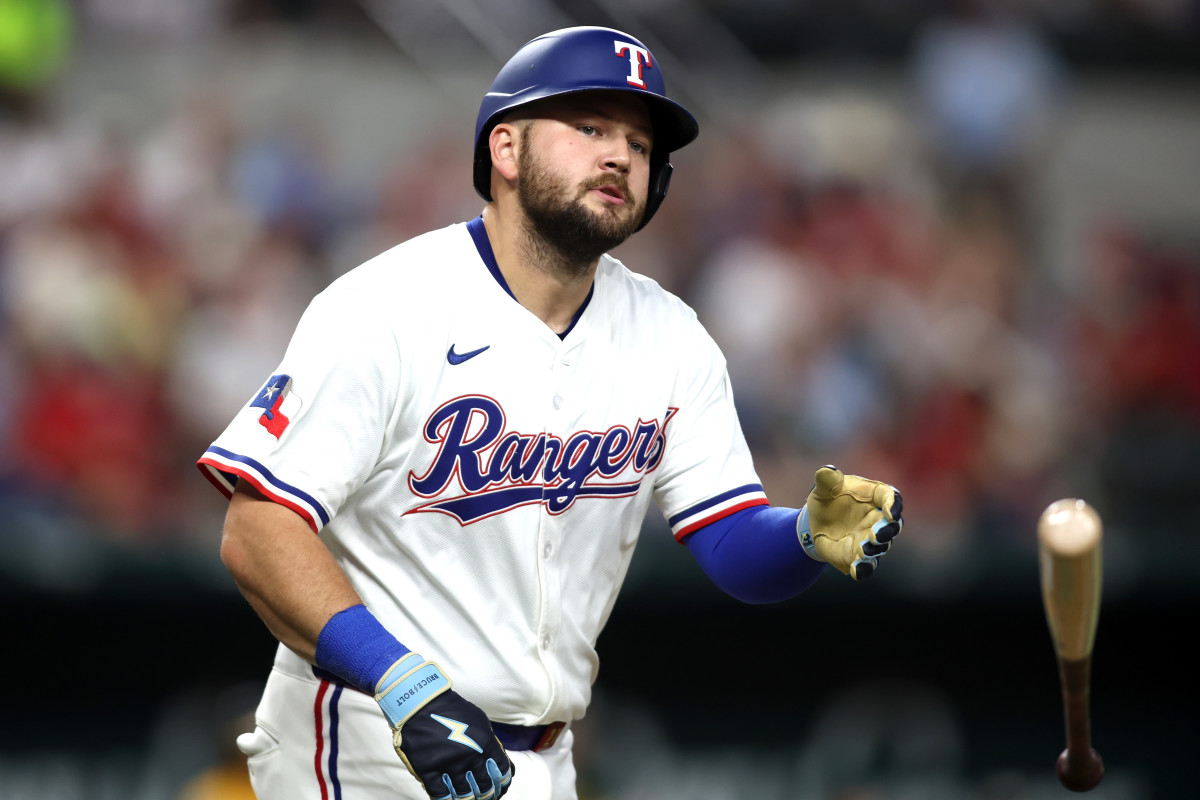 Texas Rangers first base Jake Burger tosses his bat.