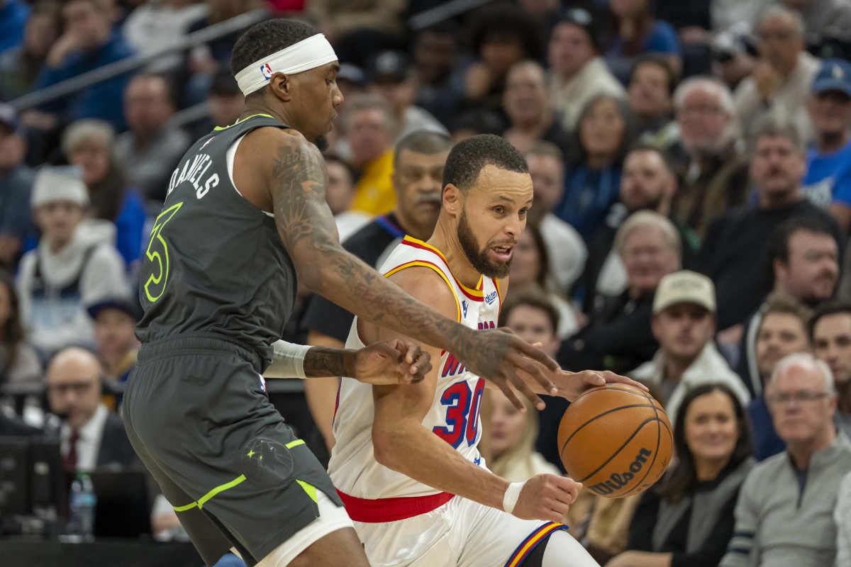 Golden State Warriors guard Stephen Curry (30) dribbles the ball against Minnesota Timberwolves forward Jaden McDaniels (3) in the second half at Target Center.