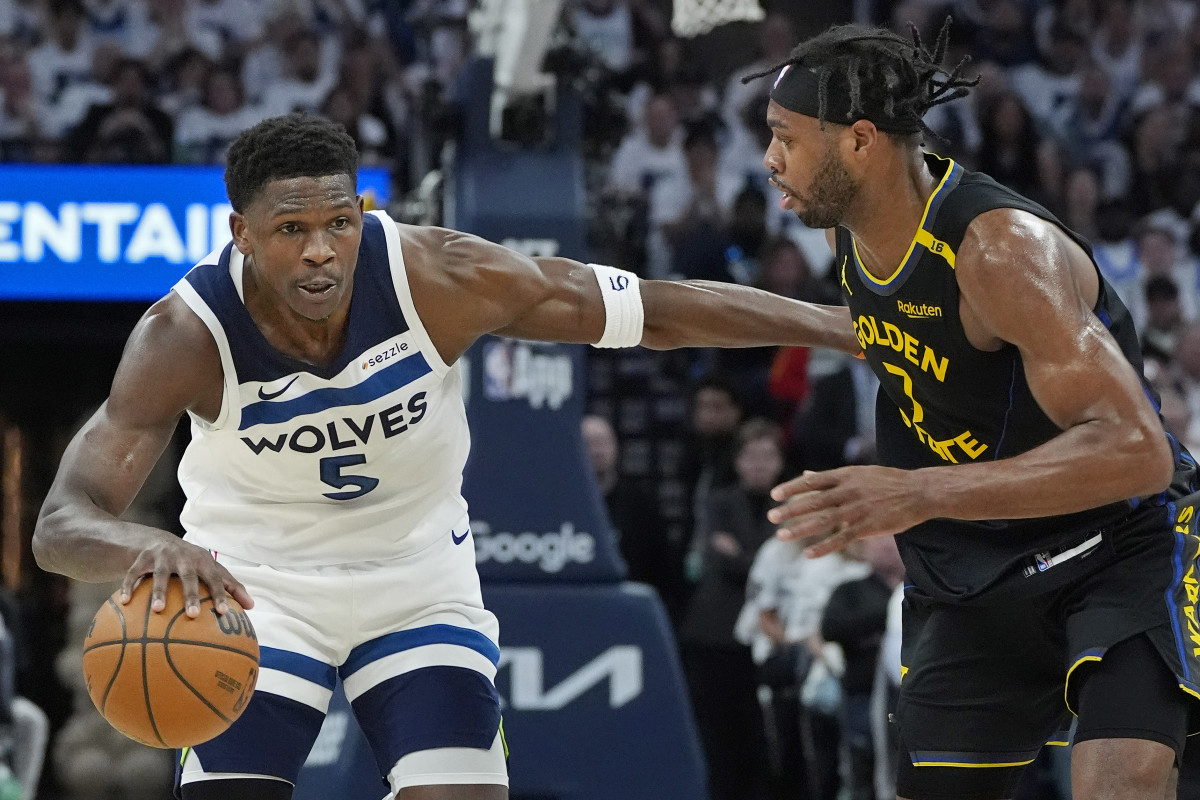 Minnesota Timberwolves guard Anthony Edwards (5) dribbles around Golden State Warriors forward Buddy Hield (7) in the first quarter during game one of the second round for the 2025 NBA Playoffs at Target Center.