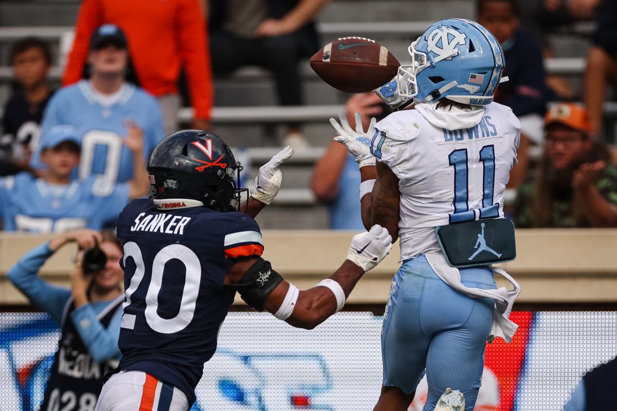 North Carolina Tar Heels wide receiver Josh Downs (11) catches a pass for a touchdown against Virginia Cavaliers defensive back Jonas Sanker (20). Mandatory Credit: Scott Taetsch-Imagn Images