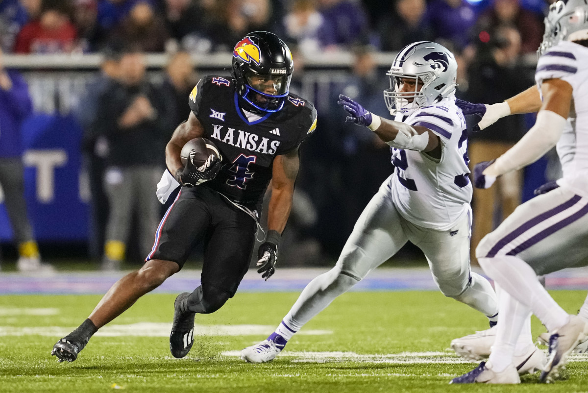 Kansas Jayhawks running back Devin Neal (4) runs the ball against the Kansas State Wildcats. Mandatory Credit: Jay Biggerstaff-Imagn Images