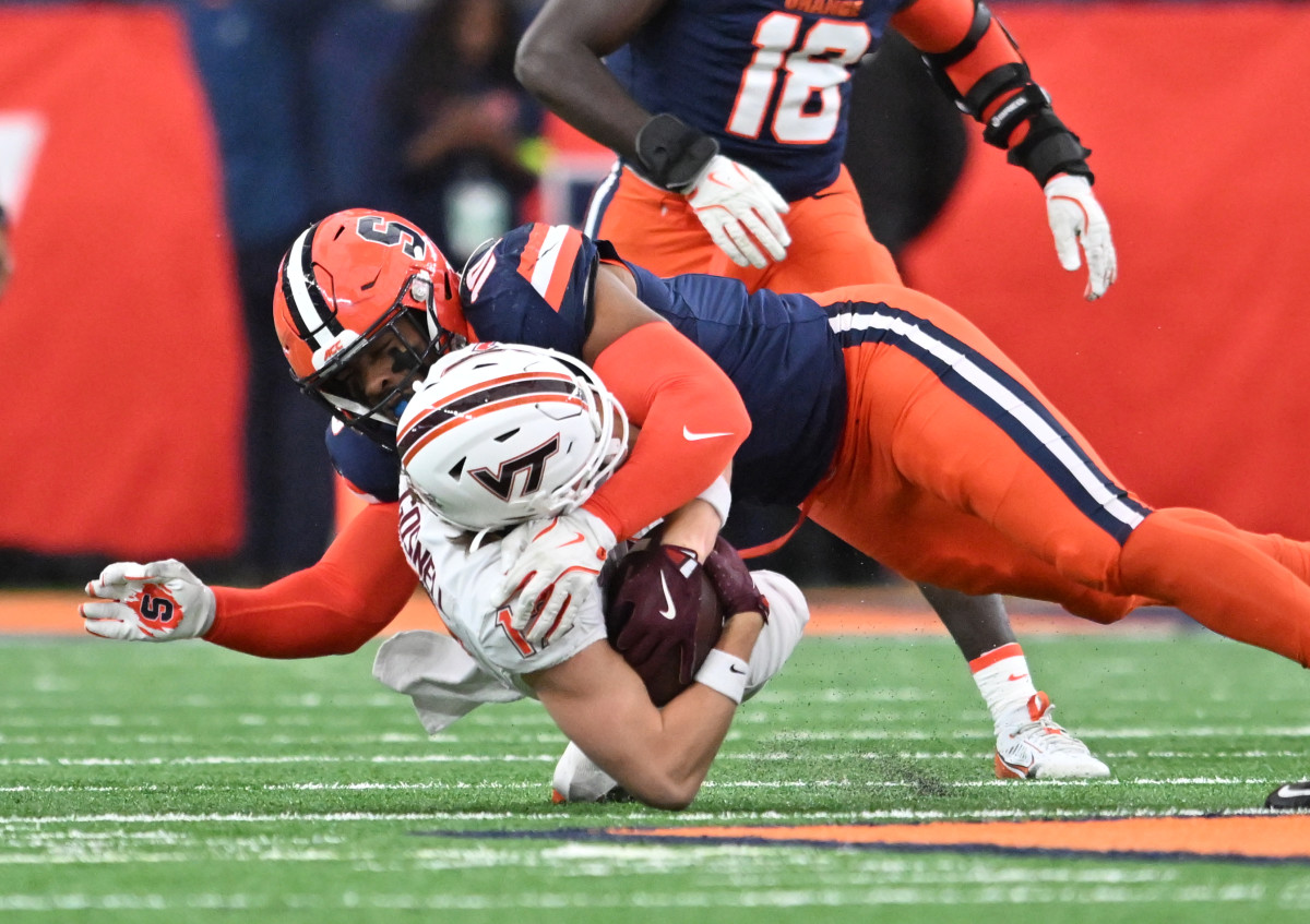 Syracuse Orange defensive lineman Fadil Diggs (10) makes a tackle on Virginia Tech Hokies wide receiver Stephen Gosnell (12). Mandatory Credit: Mark Konezny-Imagn Images