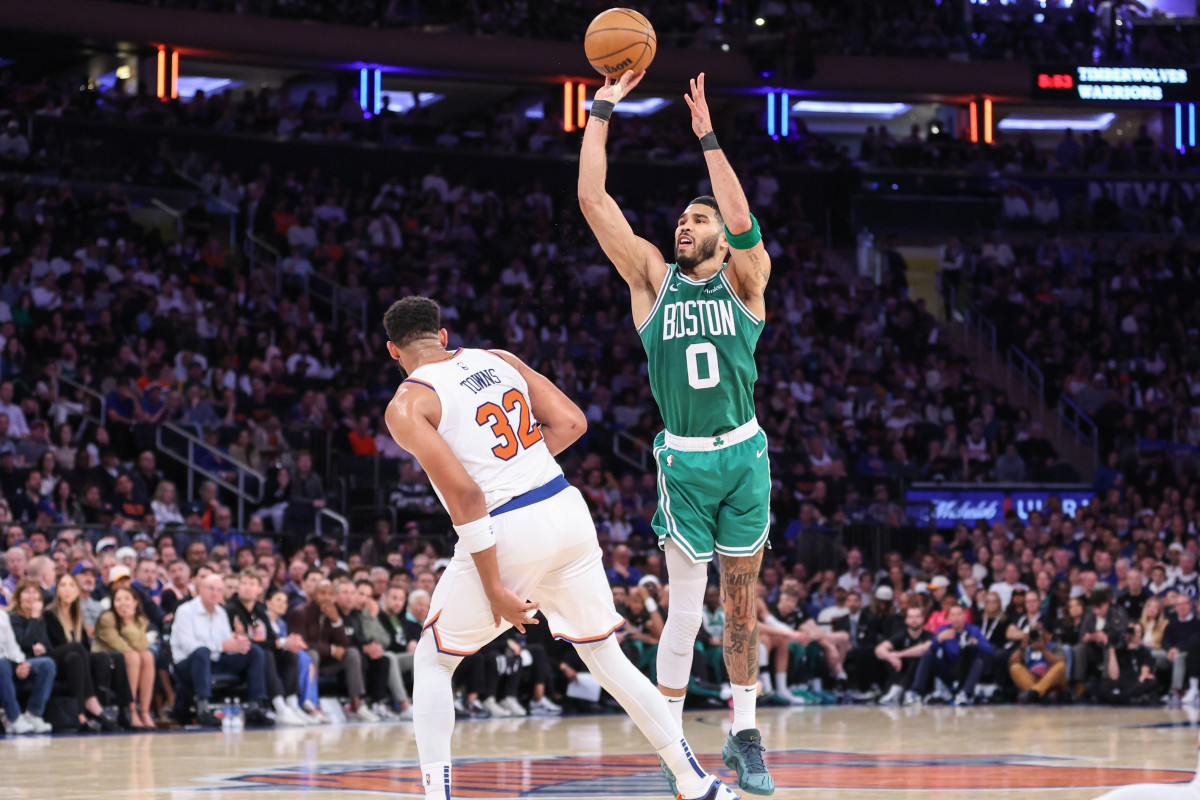 Jayson Tatum shoots vs. Karl Anthony-Towns.