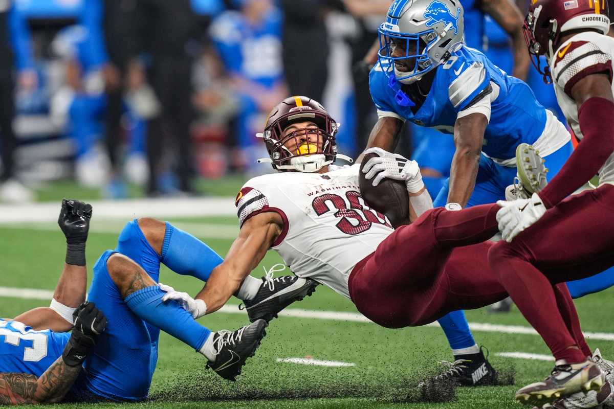 Terrion Arnold (right) makes a tackle vs. Austin Ekeler.