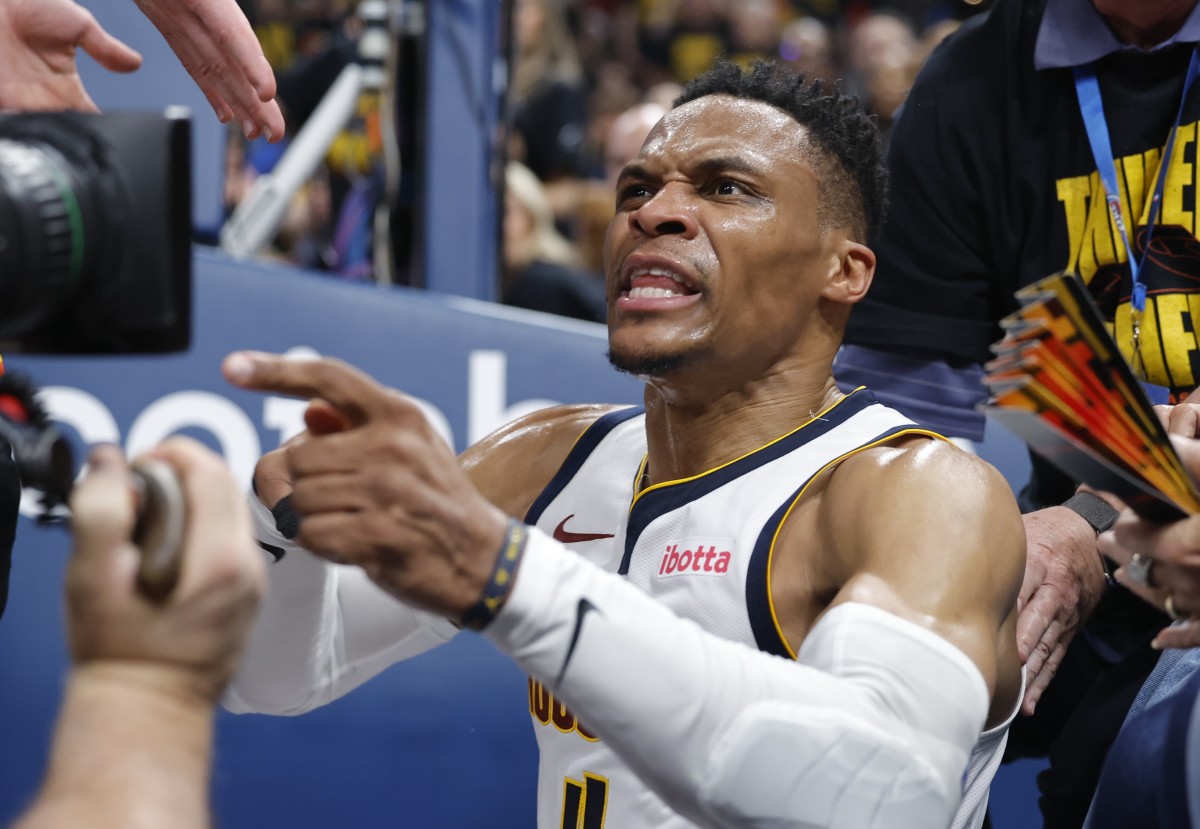 May 7, 2025; Oklahoma City, Oklahoma, USA; Denver Nuggets guard Russell Westbrook (4) reacts after a play and falling into fans in the second quarter against the Oklahoma City Thunder during game two of the second round for the 2025 NBA Playoffs at Paycom Center. Mandatory Credit: Alonzo Adams-Imagn Images  