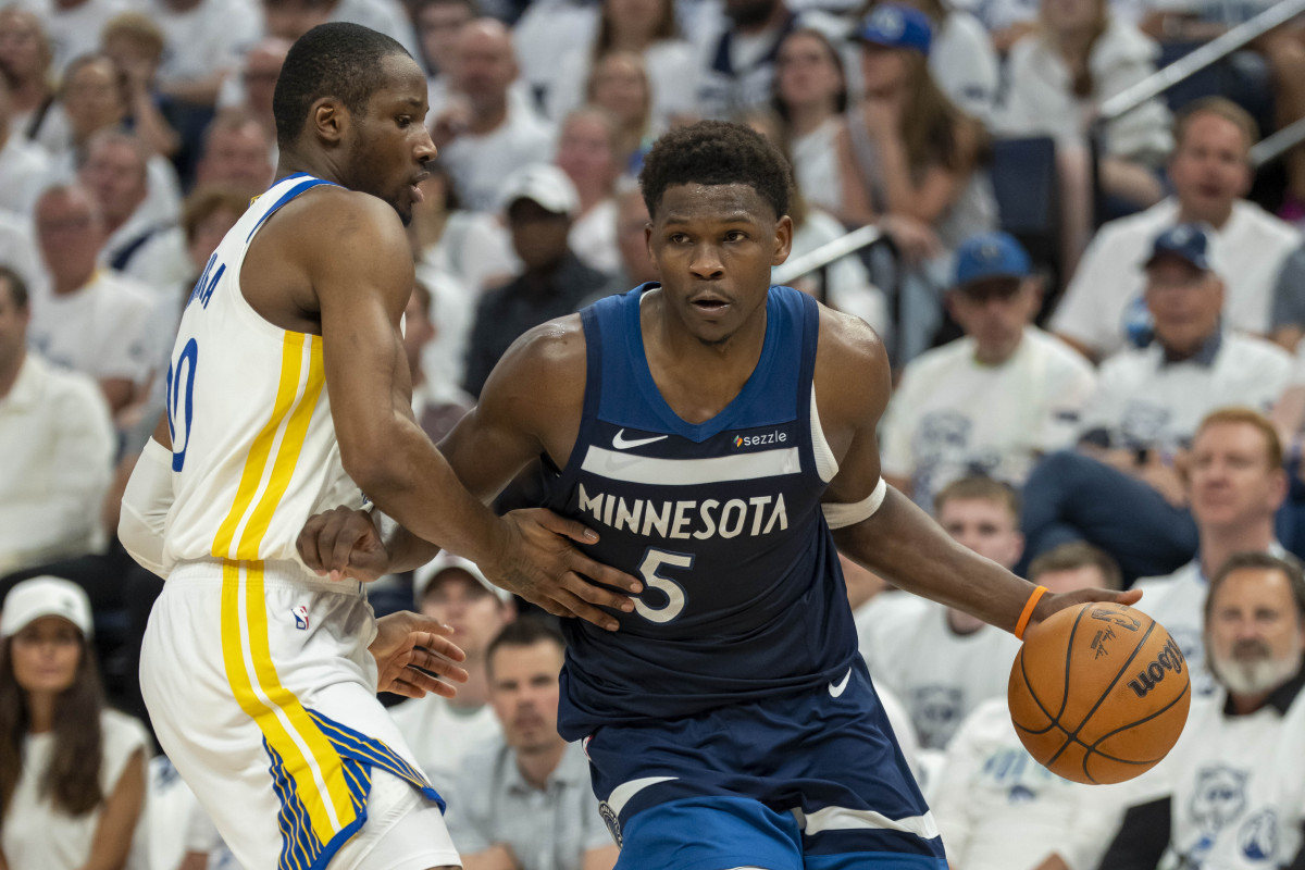 Minnesota Timberwolves guard Anthony Edwards drives past Golden State Warriors forward Jonathan Kuminga.