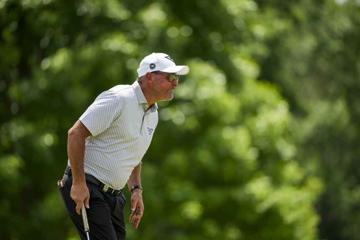 Phil Mickelson lines up his putt on the ninth hole during the first round of the PGA Championship golf tournament at Quail Hollow.