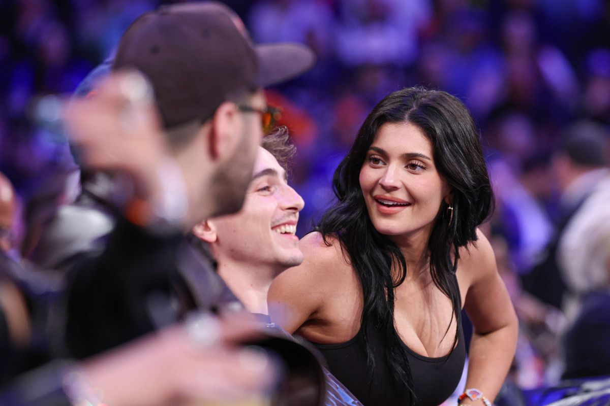 Kylie Jenner, right, sits courtside with actor Timothee Chalamet.