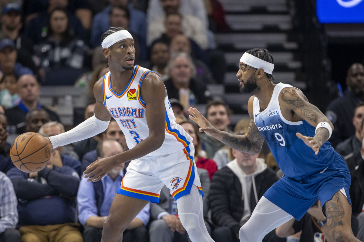 Oklahoma City Thunder guard Shai Gilgeous-Alexander (2) defended by Minnesota Timberwolves guard Nickeil Alexander-Walker (9)