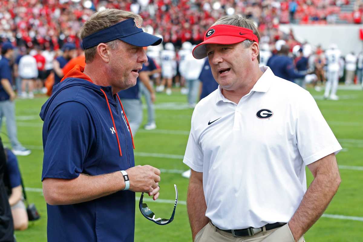 Auburn head coach Hugh Freeze speaks with Georgia head coach Kirby Smart 