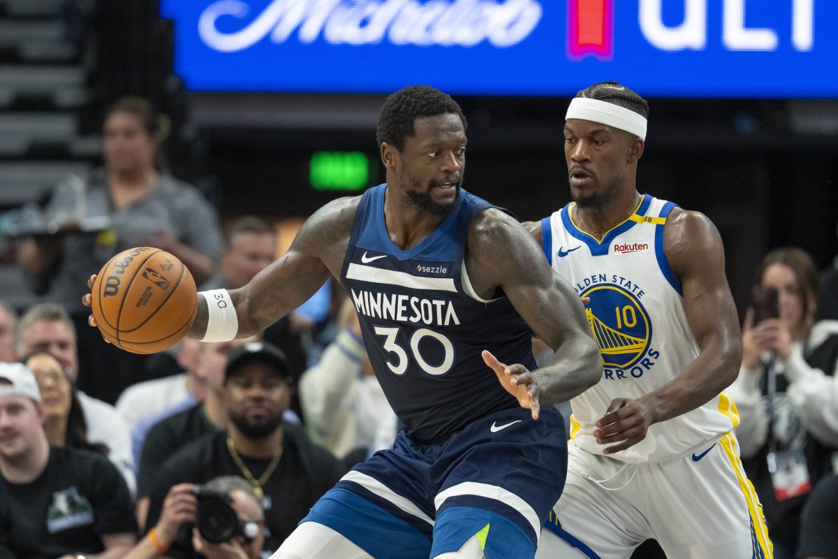 Minnesota Timberwolves forward Julius Randle operates with the ball as Golden State Warriors forward Jimmy Butler defends during their playoff game at Target Center on May 14, 2025.