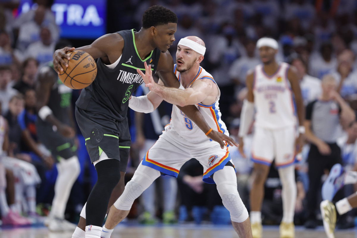 Minnesota Timberwolves guard Anthony Edwards (5) dribbles against Oklahoma City Thunder guard Alex Caruso (9) in the fourth quarter during game one of the western conference finals for the 2025 NBA Playoffs at Paycom Center.