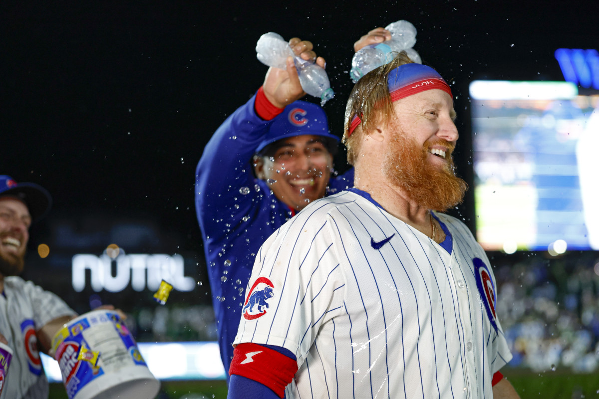 Chicago Cubs first baseman Justin Turner (3) celebrates with teammates after hitting a walk-off two-run double against the Miami Marlins during the ninth inning at Wrigley Field.