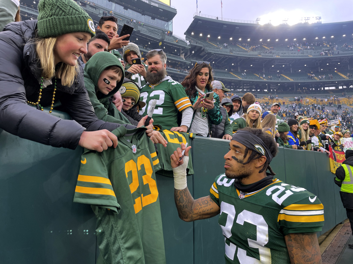 Green Bay Packers CB Jaire Alexander (23) signs autographs for fans after their game against the Los Angeles Rams at Lambeau Field.