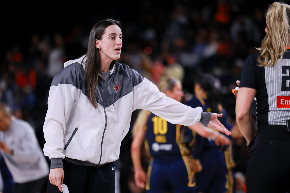Indiana Fever guard Caitlin Clark talks with the referee. 