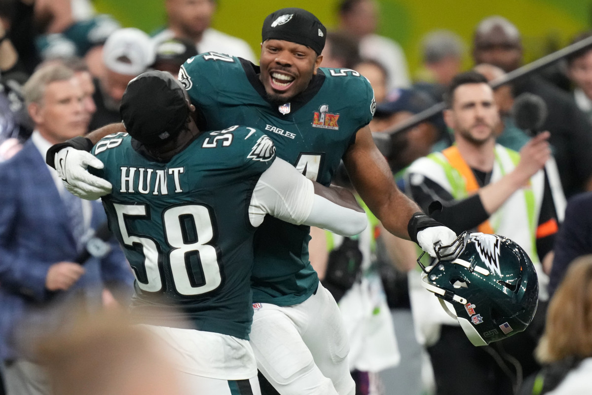 Philadelphia Eagles linebacker Jeremiah Trotter Jr. (54) reacts with linebacker Jalyx Hunt (58) after defeating the Kansas City Chiefs in Super Bowl LIX at Caesars Superdome