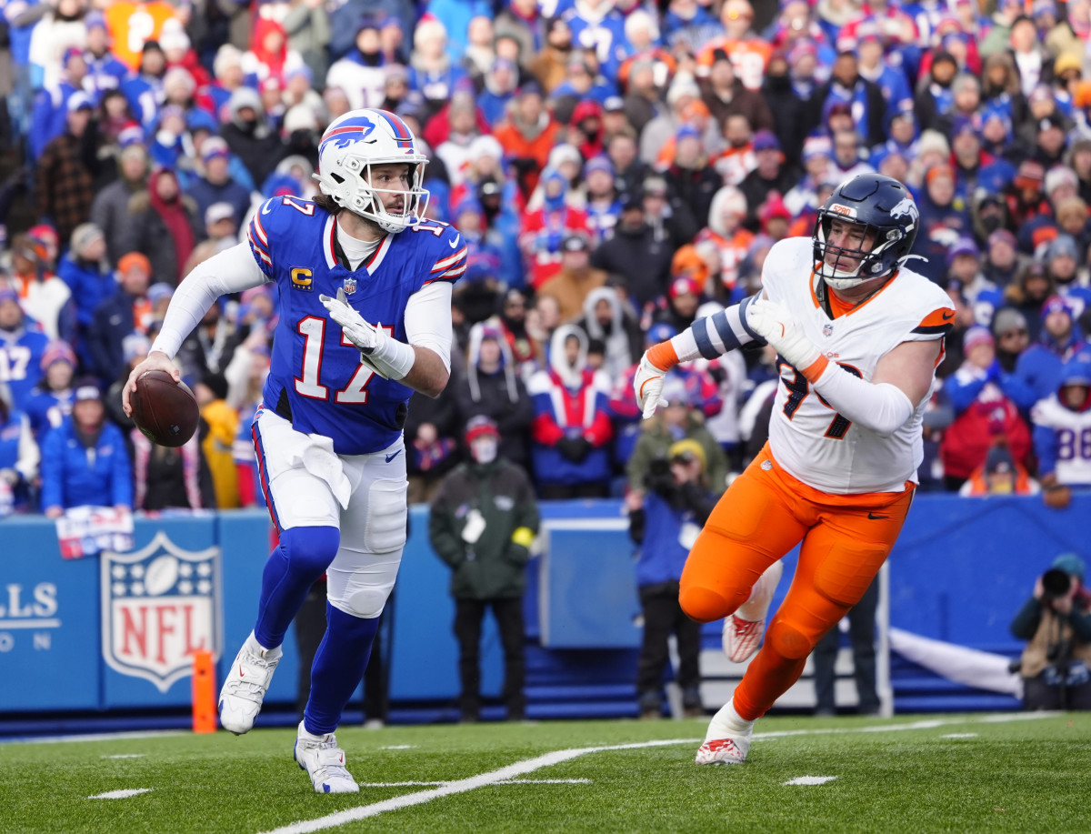Buffalo Bills quarterback Josh Allen (17) runs for a gain during the fourth quarter as Denver Broncos defensive end Zach Allen (99) defends in an AFC wild card game at Highmark Stadium.