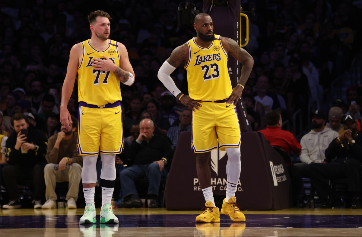 Los Angeles Lakers' Luka Doncic and LeBron James watch on against the Minnesota Timberwolves at Crypto.com Arena.