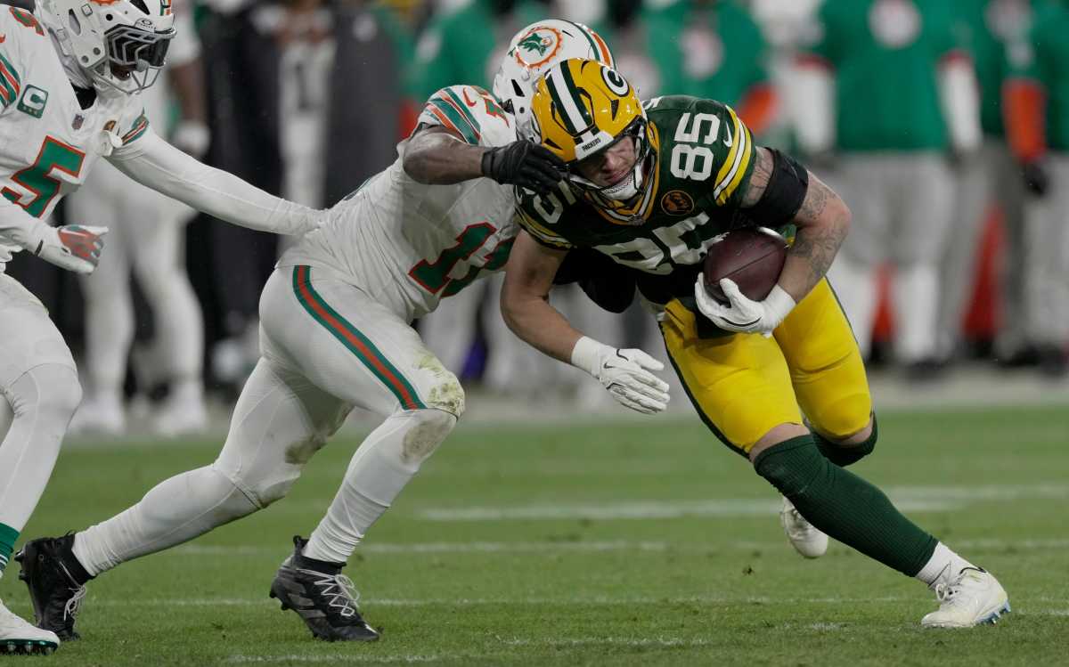 Green Bay Packers TE Tucker Kraft (85) is tackled by Miami Dolphins LB Tyrel Dodson (11) after a short reception